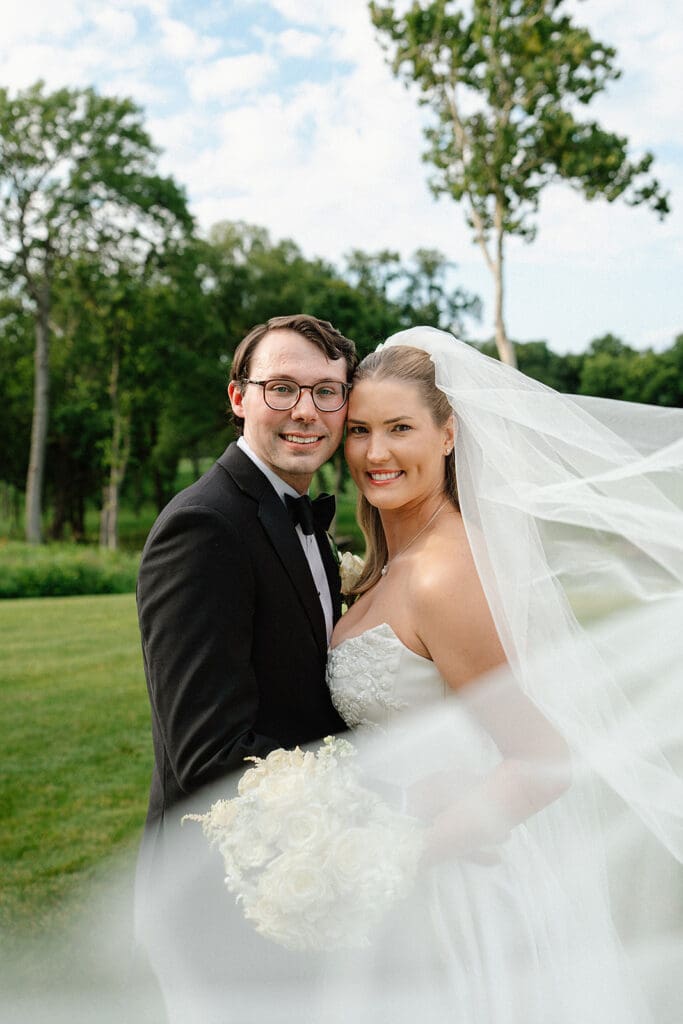 Hannah and Robert posing for romantic wedding portraits at Pinnacle Golf Club